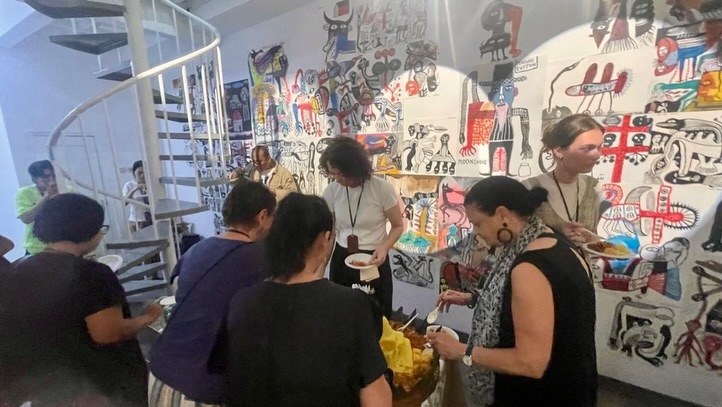 Guests gathered by the spiral staircase at Eleven Gallery
